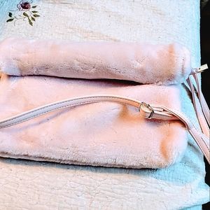 Pink Fur purse.  Roll up opening snaps shut.